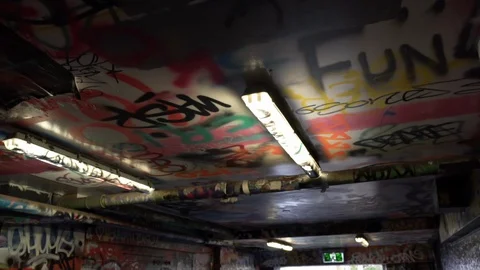 Ceiling covered in graffiti made up of words in an abandoned place, slow Vídeos de archivo 129743854