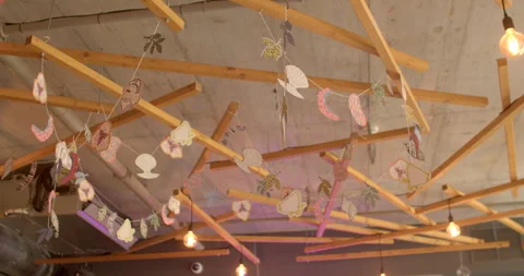 Ceiling decor elements in urban cafe, creating ambiance adding style coziness Stock Footage 248865137