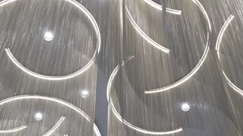 Ceiling design combines flowing lamps with hanging fringe Видео 326446177