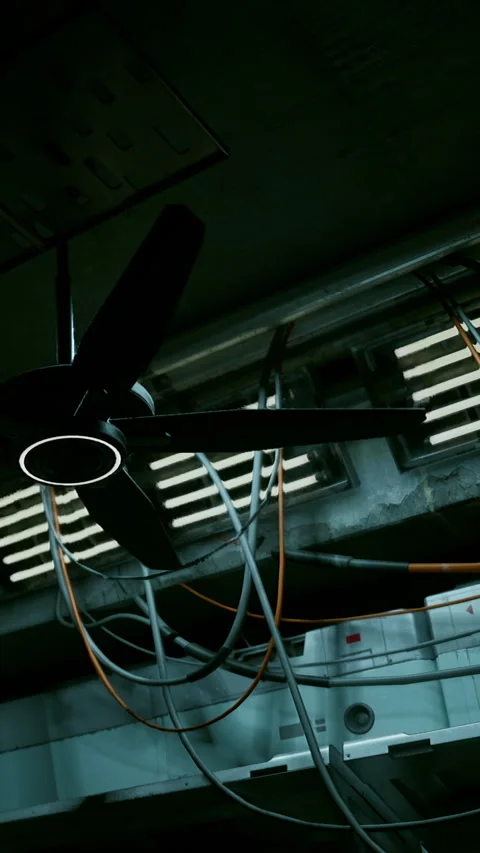 Ceiling fan and electrical wires in an indoor industrial setting Stock Footage 339410580