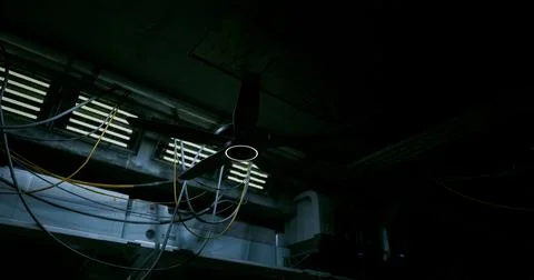 Ceiling fan in a dimly lit room with visible electrical wiring and vents Stock Illustration