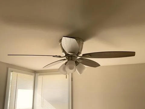 A ceiling fan in a room Stock Photos