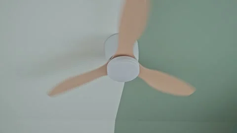 Ceiling fan spins quickly and then slows down until it stops Stock Footage 331750994