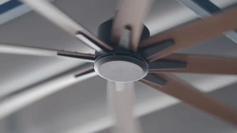 Ceiling fan spins in a quiet room during the afternoon Stock Footage 342687493