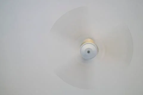 Ceiling fan turning under a white ceiling Stock Photos