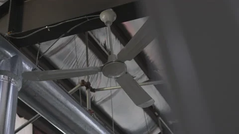Ceiling Fan Turns in Slow Motion Next to Pipe Stock Footage 208756523
