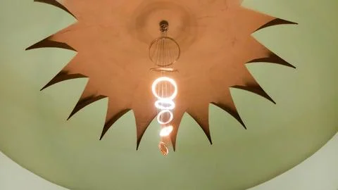 The ceiling of the grand mosque with ring-shaped decorative lights. Stock Photos