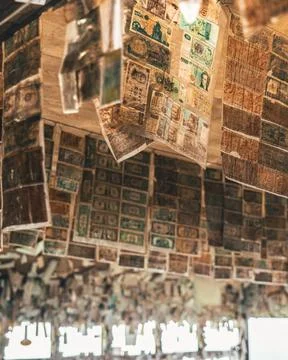 A ceiling has thousands of different bills from around the world Stock Photos