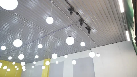Ceiling hosts rows of globe lamps like festive ornaments Vídeos de archivo 314884657