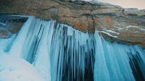 The ceiling of the ice grotto with sharp dangling spikes of ice. A rare natural Stock Footage 228883378