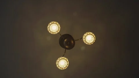 Ceiling lamp turned on in semi-dark premise of apartment Stock Footage 241913742