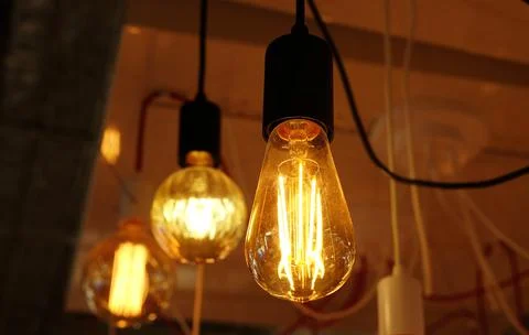 Ceiling lamps on dark background in store Stock Photos