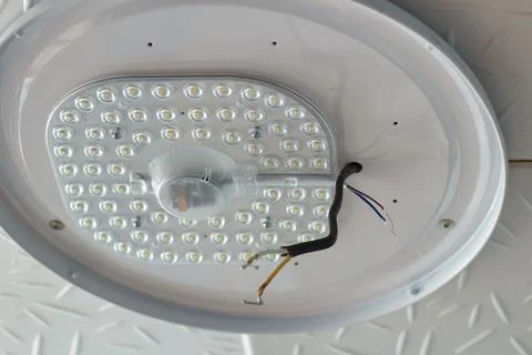 Ceiling LED lamp in disassembled form Repair in the apartment. Painting the c Stock Photos