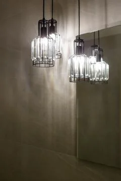 Ceiling light. Modern three-lamp chandelier. Lamp in the bathroom. Reflected  Stock Photos