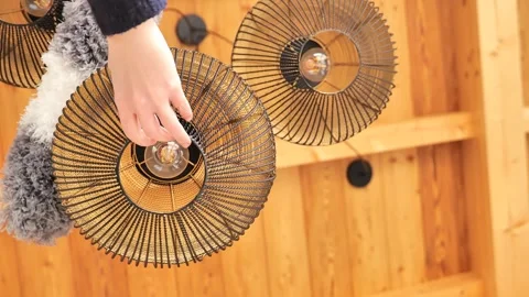 Ceiling lights cleaning. Cleaning pendant lights with a fluffy broom Stock Footage 262832762