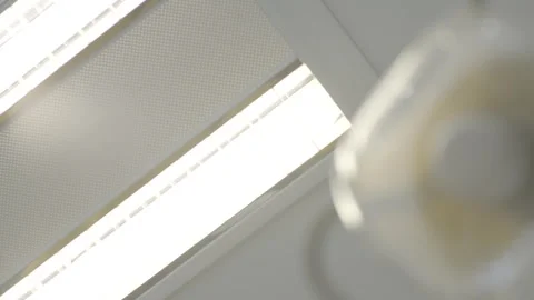 Ceiling lights in an office turn on and off Video stock 280095857