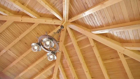 Ceiling Lights of Wooden Dining Deck Canted Pan Shot Video stock 76462196