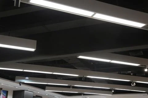 The ceiling is lit up with bright lights Stock Photos