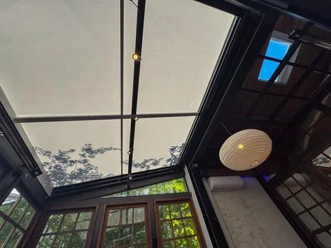 Ceiling made of a fabric in a restaurant. The shadow of trees and leaves rustlin Stock Photos