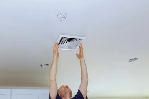 Ceiling Mounted Air Conditioner. New white air conditioning vent closeup Stock-Fotos