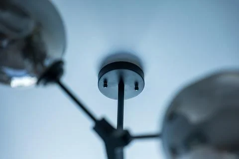 Ceiling-mounted electrical outlet and conduit against blue sky, Minsk Fotos Stock