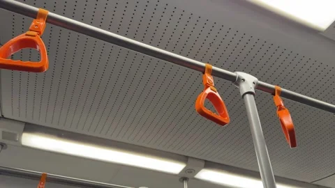 Ceiling mounted handrail with bright colored triangular hanging grips Stock Footage 321190916