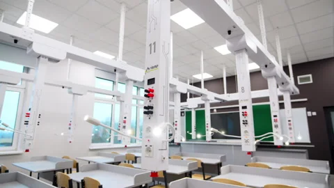 Ceiling-mounted power console hangs above organized desks 動画素材 332269183