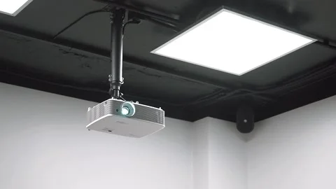 The ceiling mounted projector lights up Stock Footage 131567045