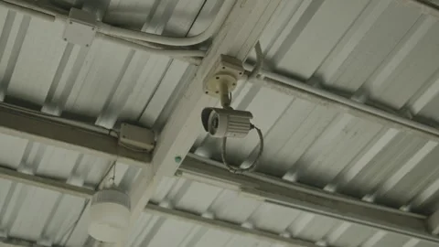 Ceiling-mounted security camera under corrugated metal roof Stock-Footage 347035669