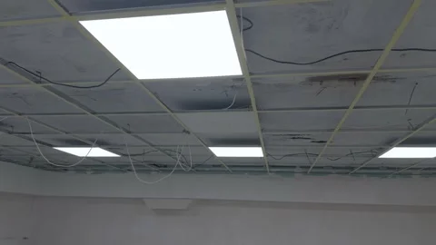 Ceiling panels and light fixtures are installed in a suspended frame Stock Footage 340358374