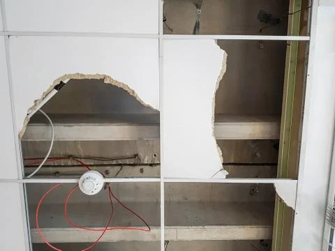 Ceiling panels damaged and collapsed by water. Stock Photos