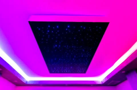 Ceiling of a spa center with colored lights and geometric perspective Stock Photos