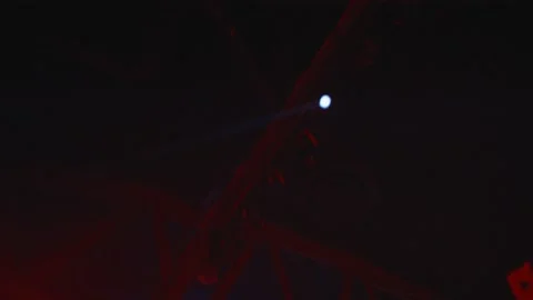 Ceiling spotlight light beams in venue rafters Stock Footage 136342392