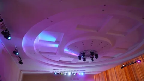 Ceiling spotlights are spinning in a circle surrounded by many lamps. Stock Footage 247553862