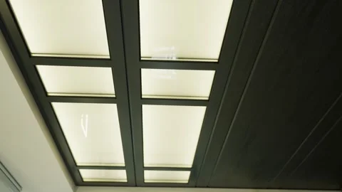 Ceiling structure with panels and lighting fixtures in neutral interior space Stock Footage 346218777