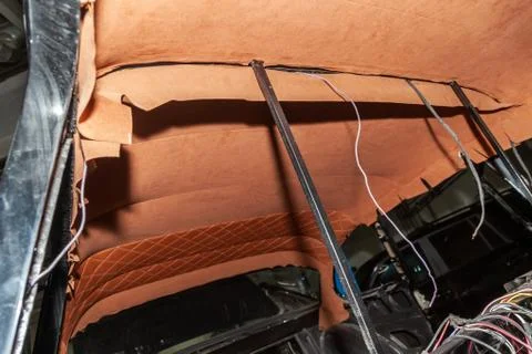 The ceiling of the SUV car pulled by bbrown and orange soft material in the w Photos