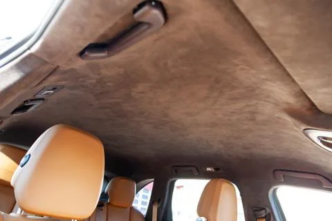 The ceiling of the SUV car pulled by brown soft material alkantara in the wor Photos