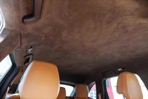 The ceiling of the SUV car pulled by brown soft material alkantara in the wor Photos