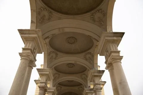 A ceiling with various carved decorations and columns Stock Photos