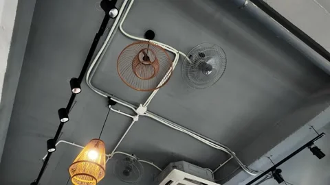 Ceiling view: bright lamps, spinning ceiling fans, and air conditioning vents Stock Footage 280243403