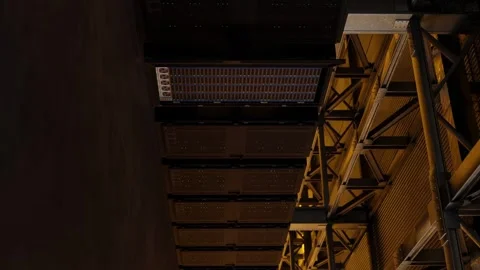 Ceiling view of industrial server racks in high-tech data center with yellow Stock Footage 311418696