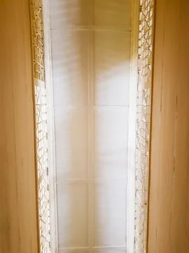 The ceiling is viewed from below in a room with a dominant cream color. Stock Photos