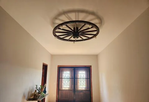 Ceiling with Wagon Wheel Chandelier Stock Photos