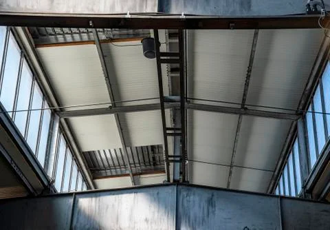 Ceiling of a warehouse with light openings and iron beams Stock Photos