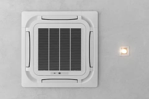 Ceiling white air conditioner built into the ceiling next to the ceiling Stock Photos