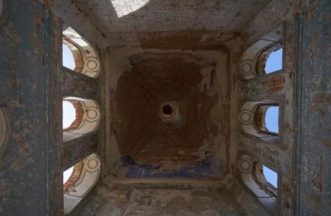 Ceiling with windows in a tall tower inside an abandoned church Stock Photos