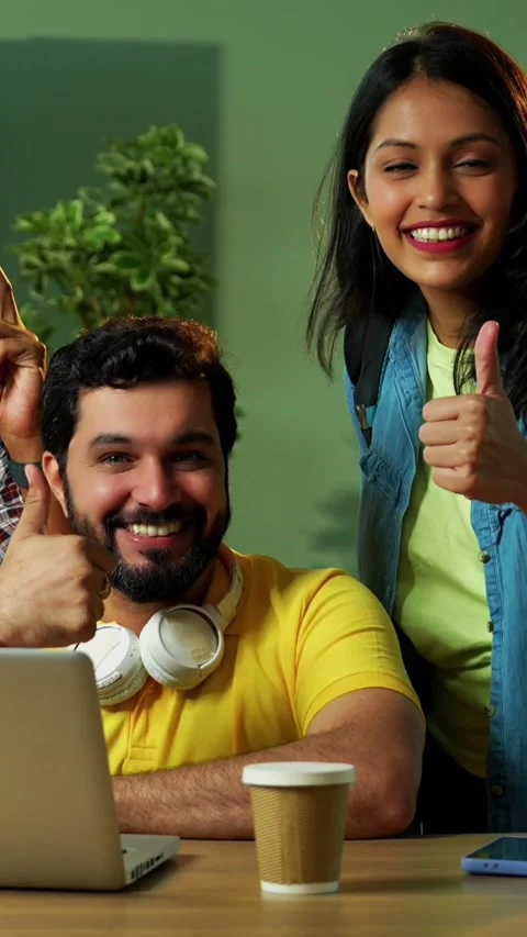 Celebrating assignment success, Indian students study together using laptop Stock Footage 342384997