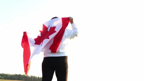 Celebrating Canada with pride in a vast open landscape Stock Footage 295256400