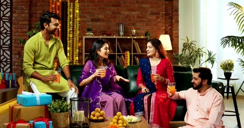 Celebrating Diwali while cold drink with Indian couple and friends in festival Stock Footage 342382489