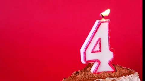 Celebrating fourth birthday with cake and candles in a vibrant atmosphere Stock Footage 295190834
